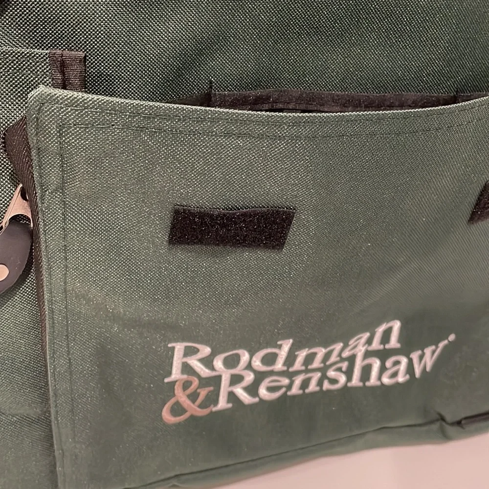 Dark green canvas briefcase with laptop sleeve and multiple pockets. NWT